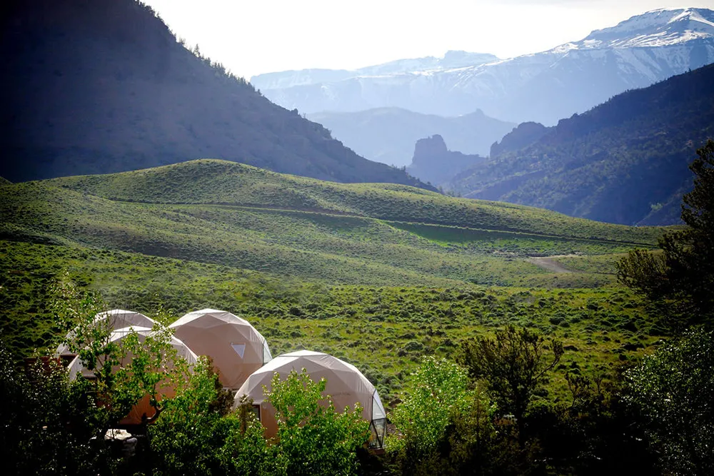 Pure Heart Retreat Lodging Domes with snow-crested mountains in the background